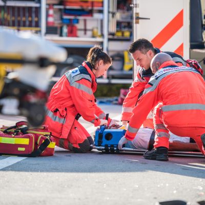 Medical personel securing wounded in the street.